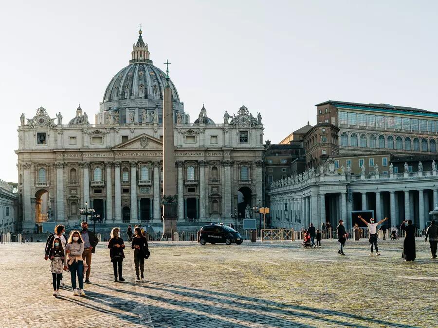 Tourists in St Peter's Square in the Vatican, wearing face masks