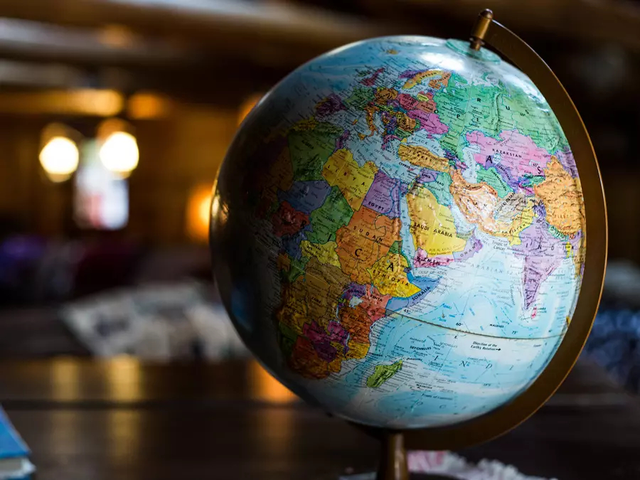A world globe standing on a desk
