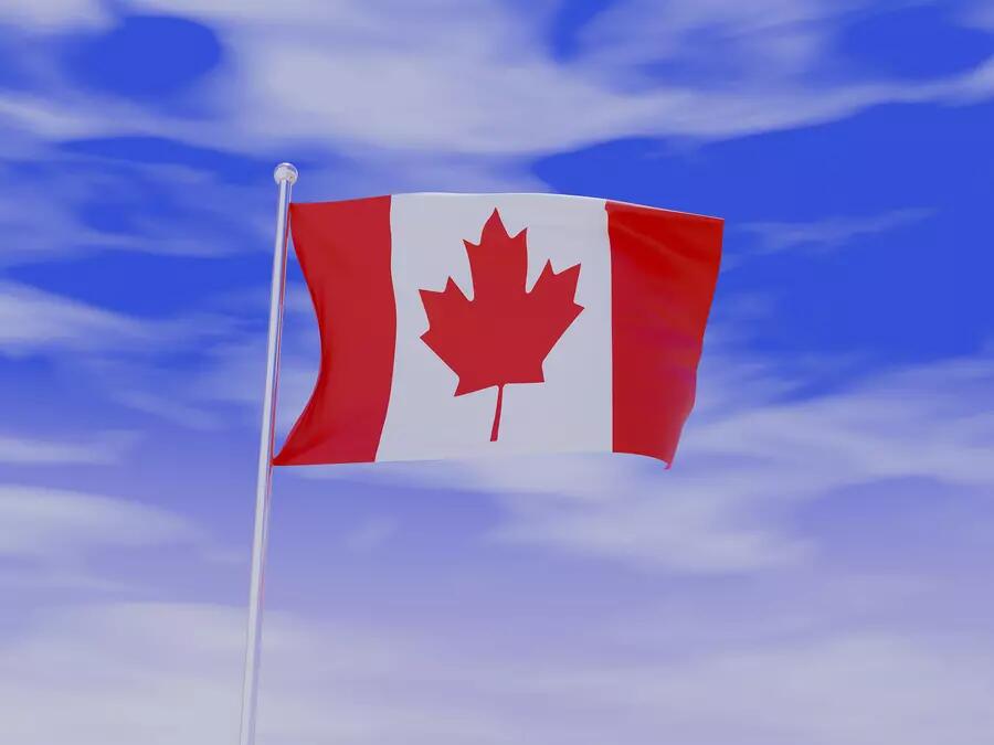 Canadian flag against a sky blue background with clouds