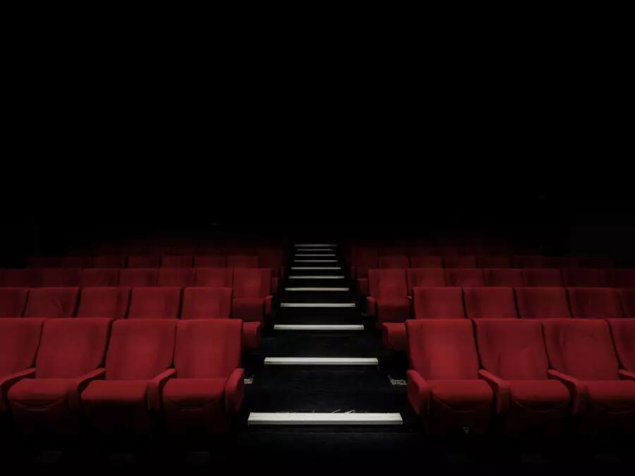 Dark theatre with red velvet seats