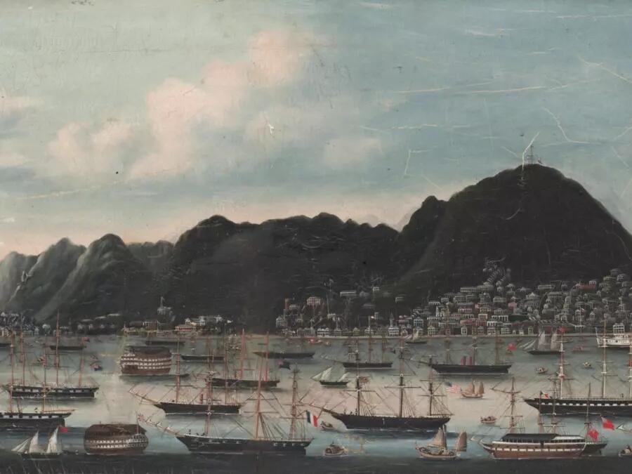 Painting of an old harbour with multiple ships in the water