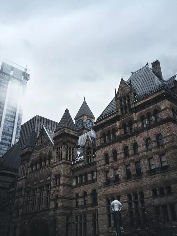 Old City Hall in Toronto, Ontario, with a grey sky background.