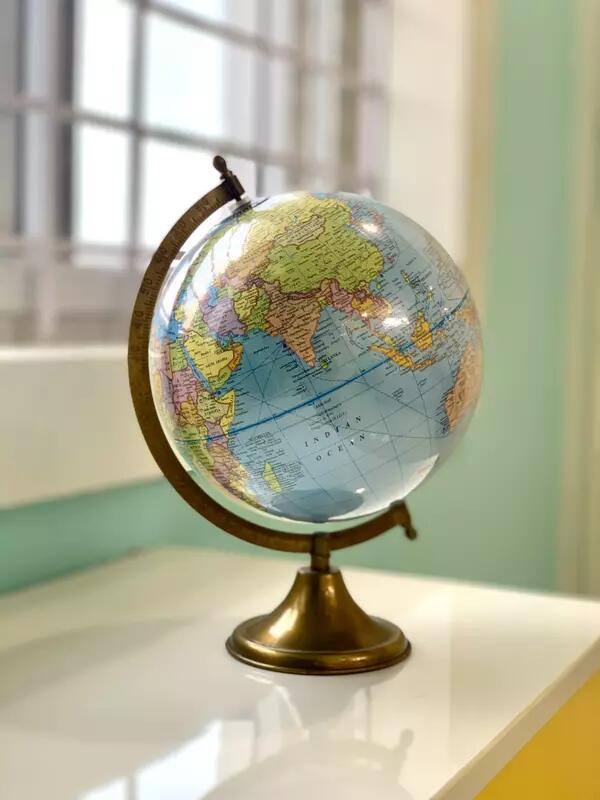 A globe sitting on a white countertop.