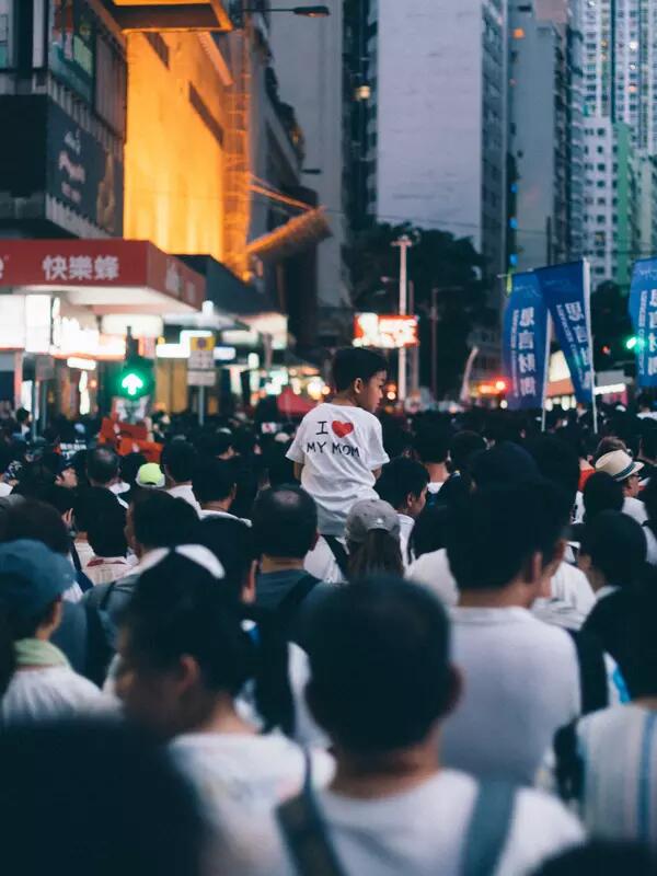 Shot of protest in Hong Kong, showing backs of protesters in white shirts