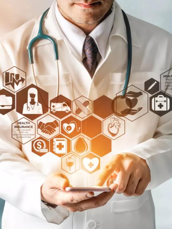 A doctor wearing a white coat and a stethoscope holds a tablet with small icons in a honeycomb formation appear emanating from the screen 