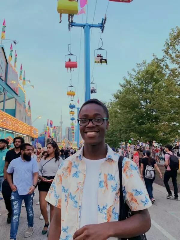 Joel Ndongmi smiling at a street fair