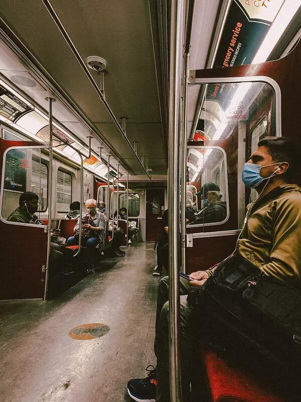 Masked individuals ride the subway in Toronto