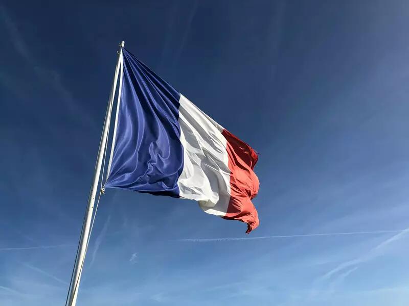 The flag of France against a blue sky
