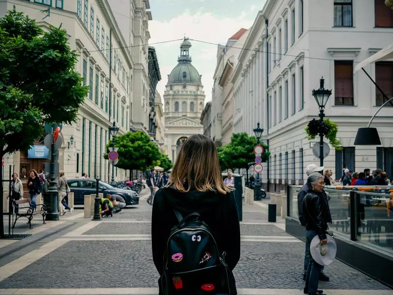 The back of a female walking towards St. Stephen's Basilica in Budapest, Hungary