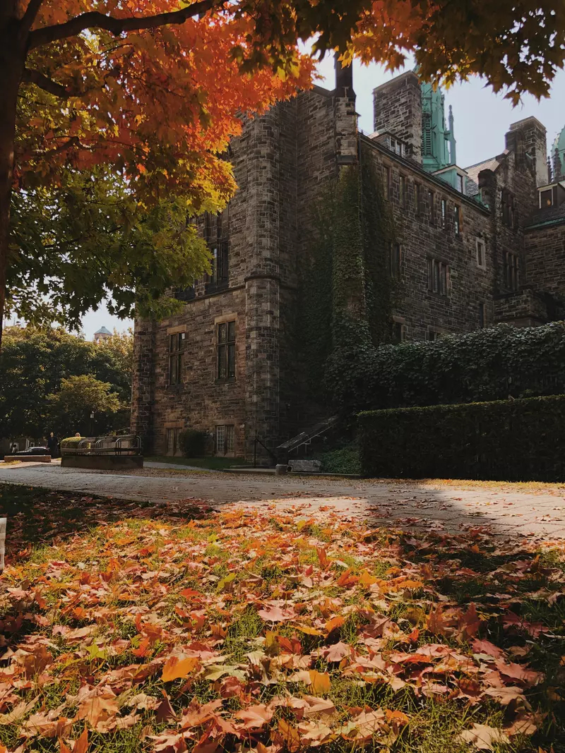Shot of a stone building on the University of Toronto campus in the fall.
