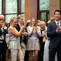 Students take photos with family and friends at the Munk School Convocation