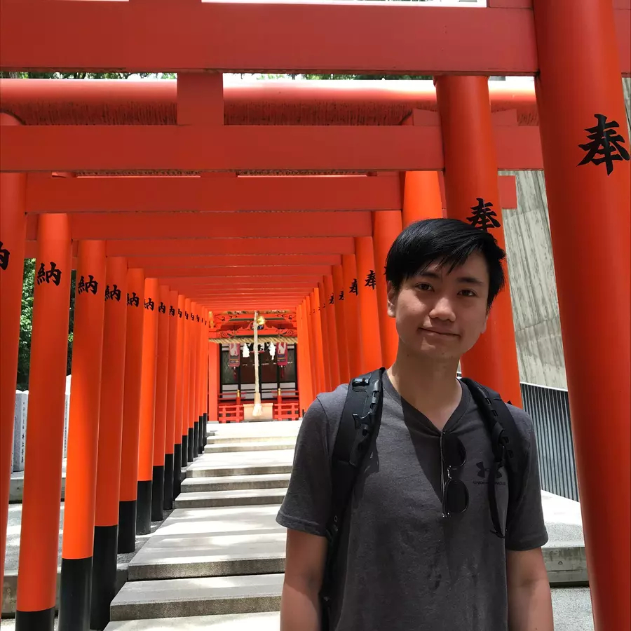Student standing in front of a temple in Japan